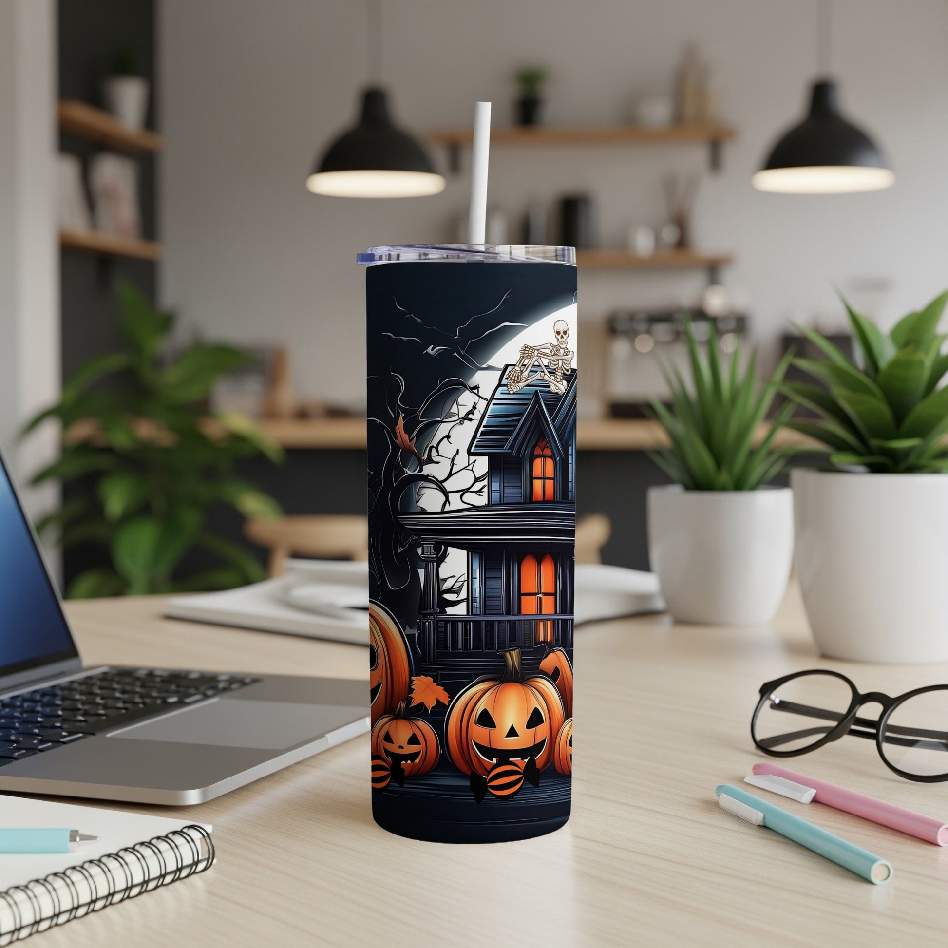 Halloween tumbler with haunted house, pumpkins, and skeleton design.