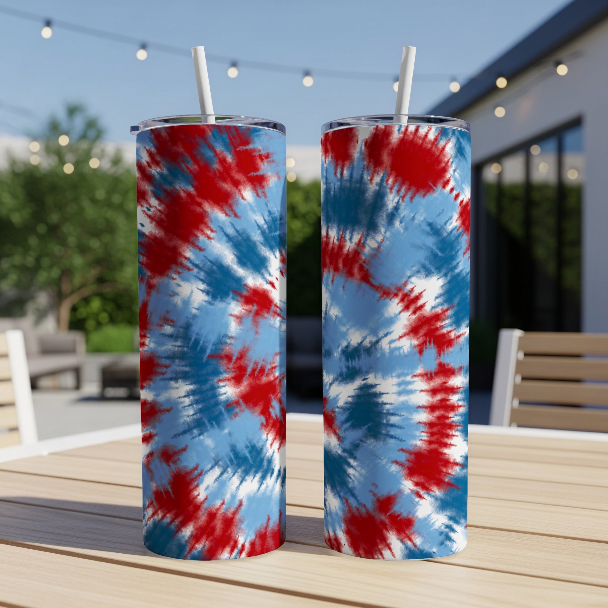 Two tumblers with red, white, and blue tie-dye pattern on outdoor table