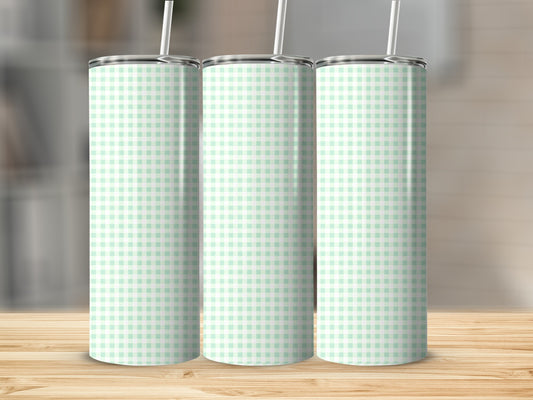 Three mint green and white gingham print tumblers with straws.