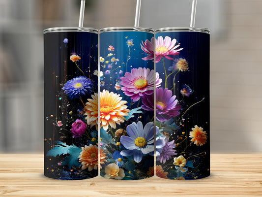Three tumblers with vibrant floral designs on a wooden surface.
