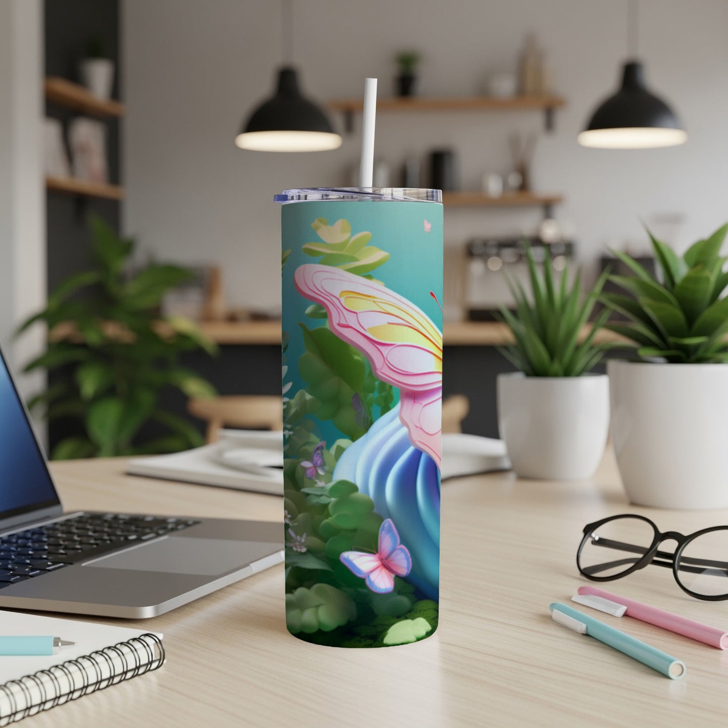 Tall tumbler with colorful butterfly and floral design on a desk.