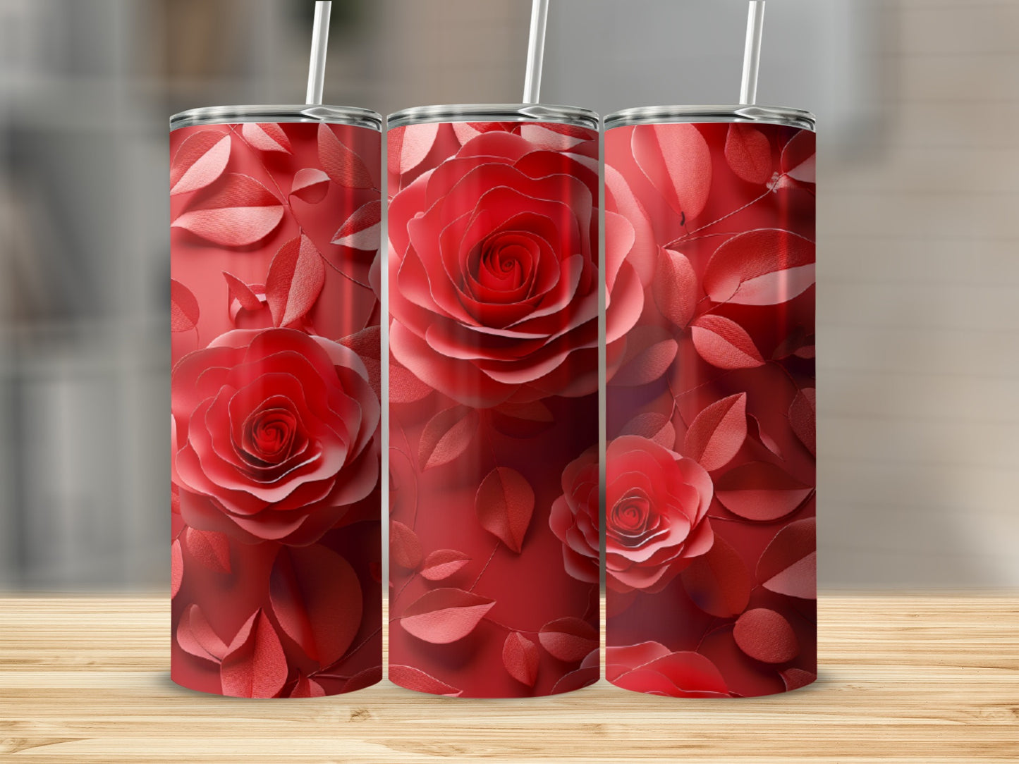 Three red rose tumblers with lids and straws, displayed on a wooden surface.
