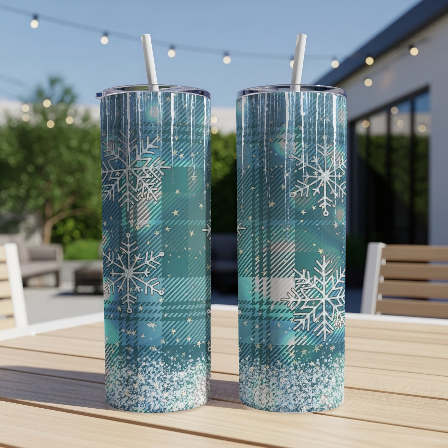 Two turquoise plaid tumblers with snowflakes and glitter accents.