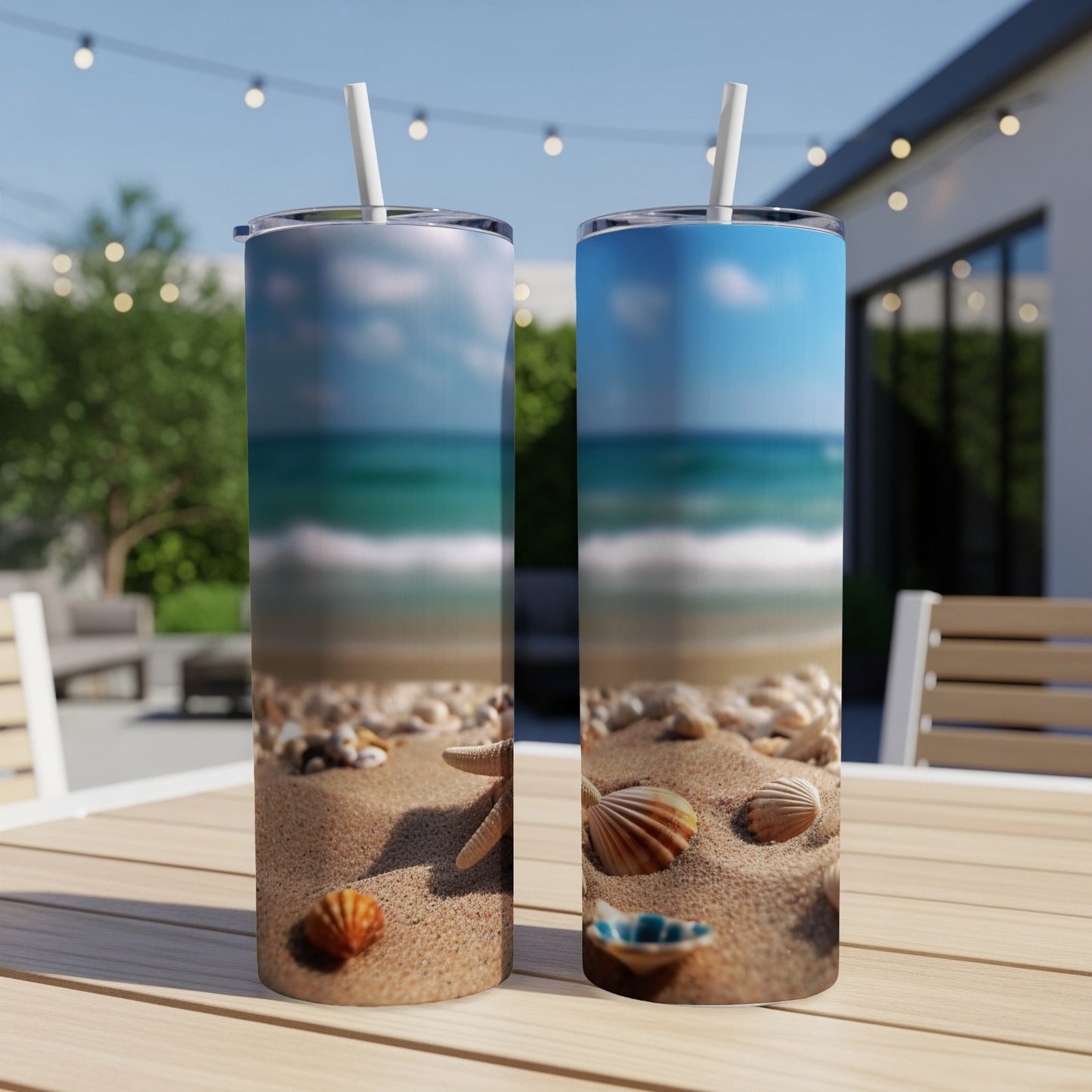 Two tumblers with a beach scene on a table.
