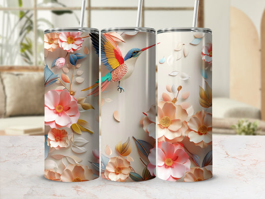 Floral and hummingbird patterned tumbler with a straw.
