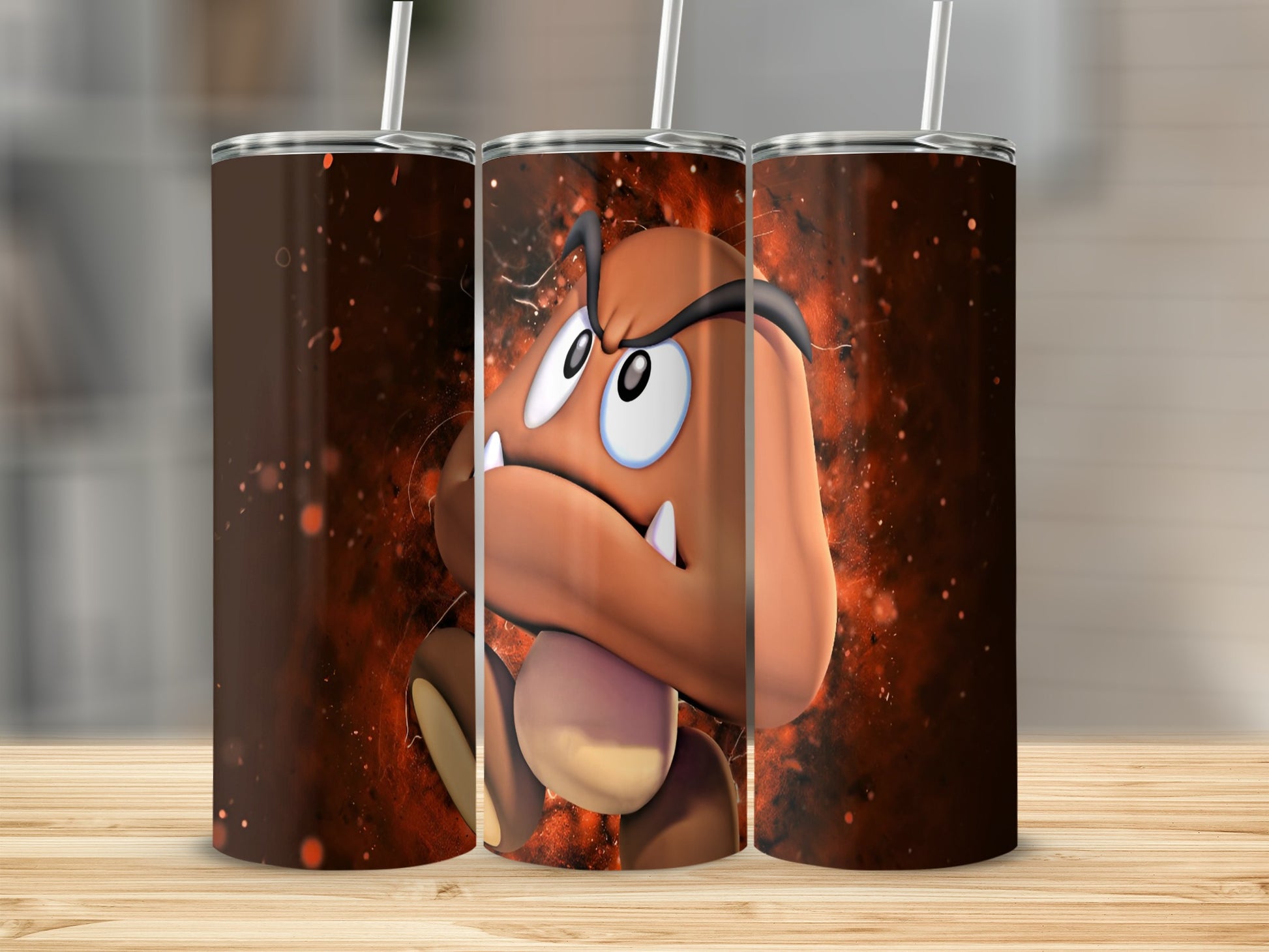 Goomba character from Super Mario, three cups with artwork, wooden surface.