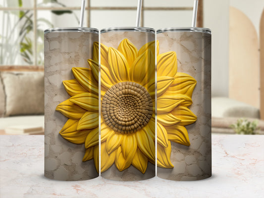 Sunflower patterned tumbler with straw and textured background.