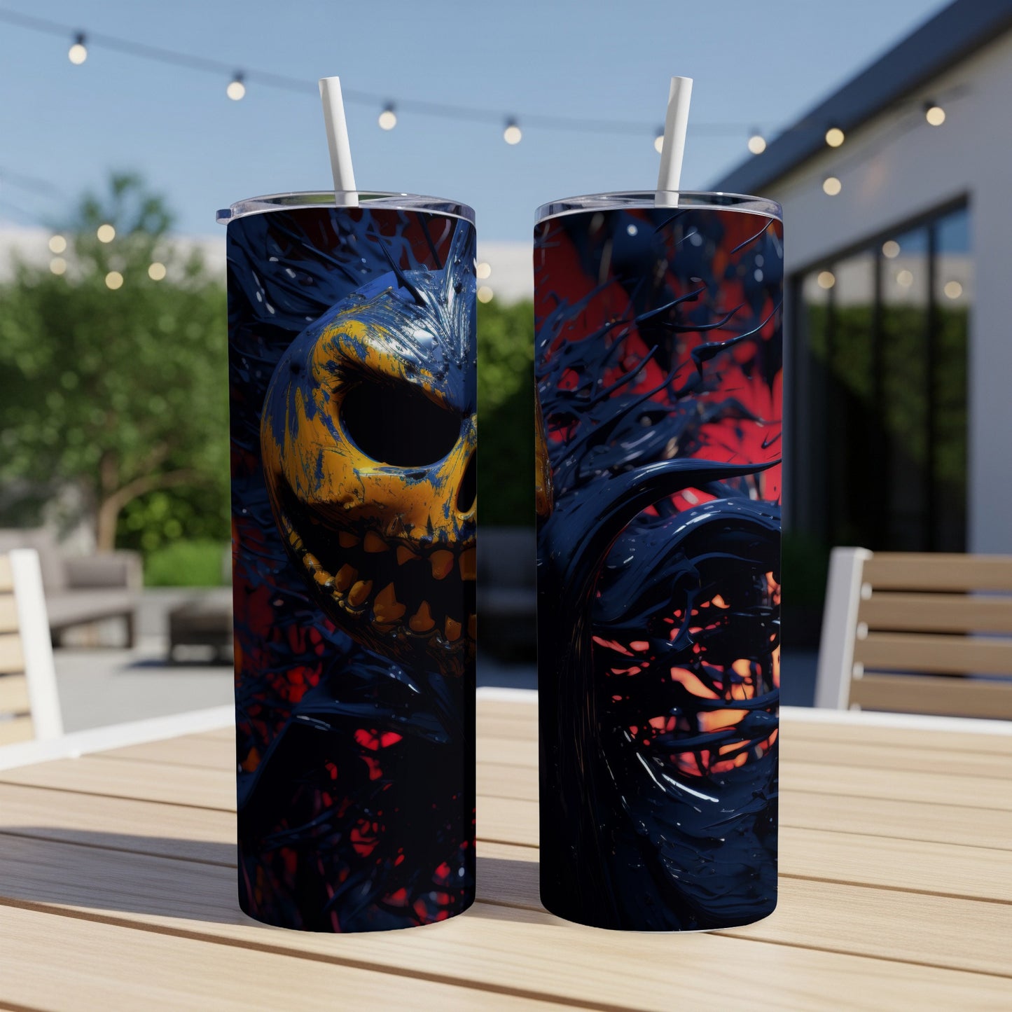 Two tumblers with a yellow and blue monstrous face design, on a table.