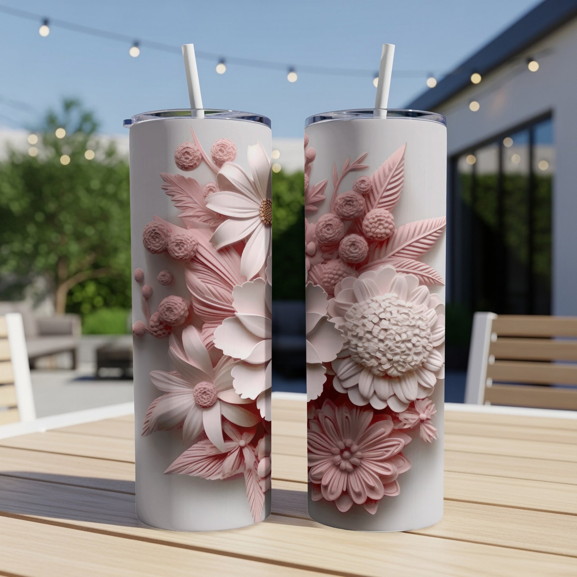 Two pink floral patterned tumblers on a wooden table.