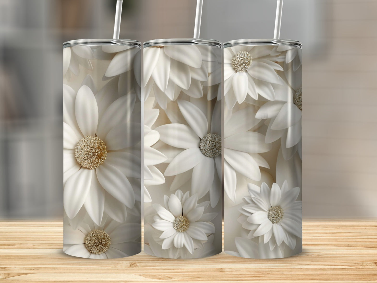 Three tumblers with a white floral pattern and straws on a wooden surface.