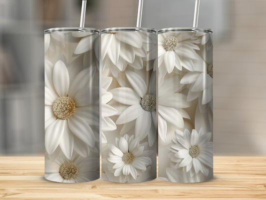 Three tumblers with a white floral pattern and straws on a wooden surface.