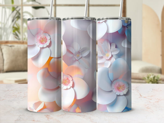 Three tumblers with pastel floral designs and white petals.