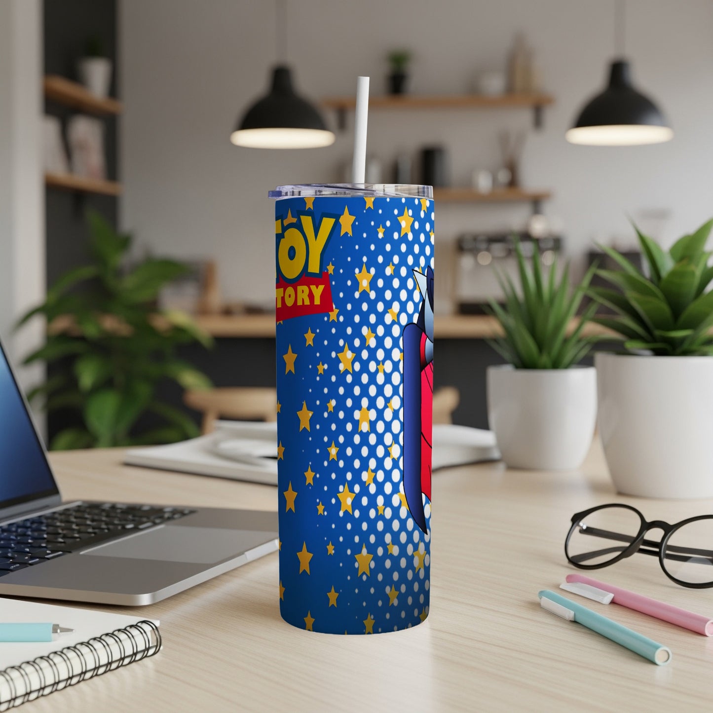Blue tumbler with Toy Story characters and yellow stars, straw inserted.
