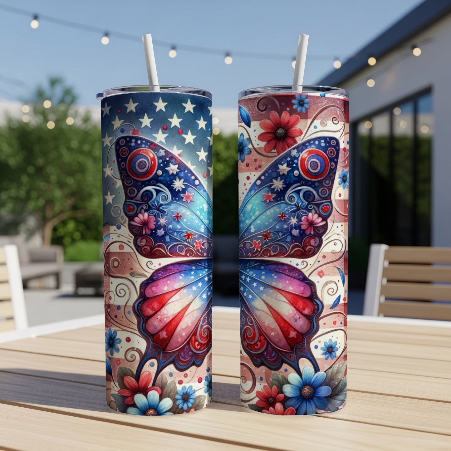Two patriotic butterfly tumblers with stars and flowers on a wooden table.