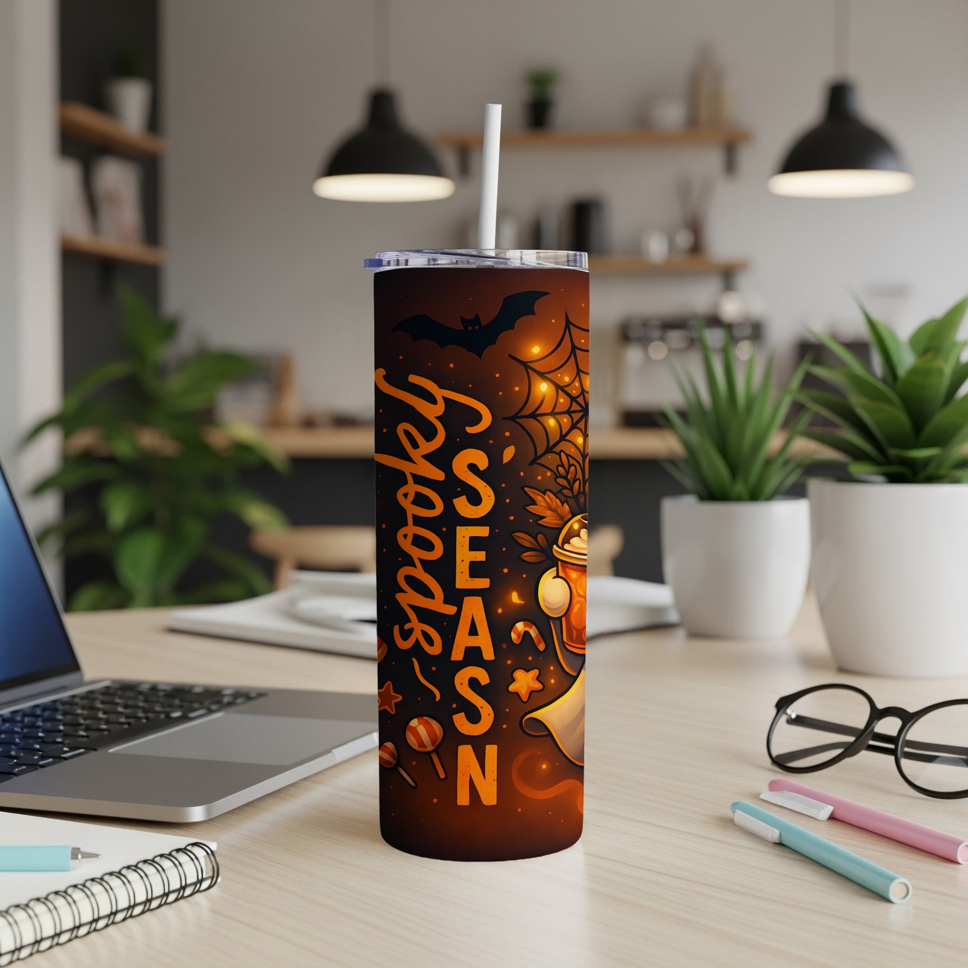 Halloween tumbler with "spooky season" text, bat, spiderweb, and candy designs.