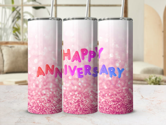 Tumbler with "Happy Anniversary" in colorful balloon letters on a pink glitter background.