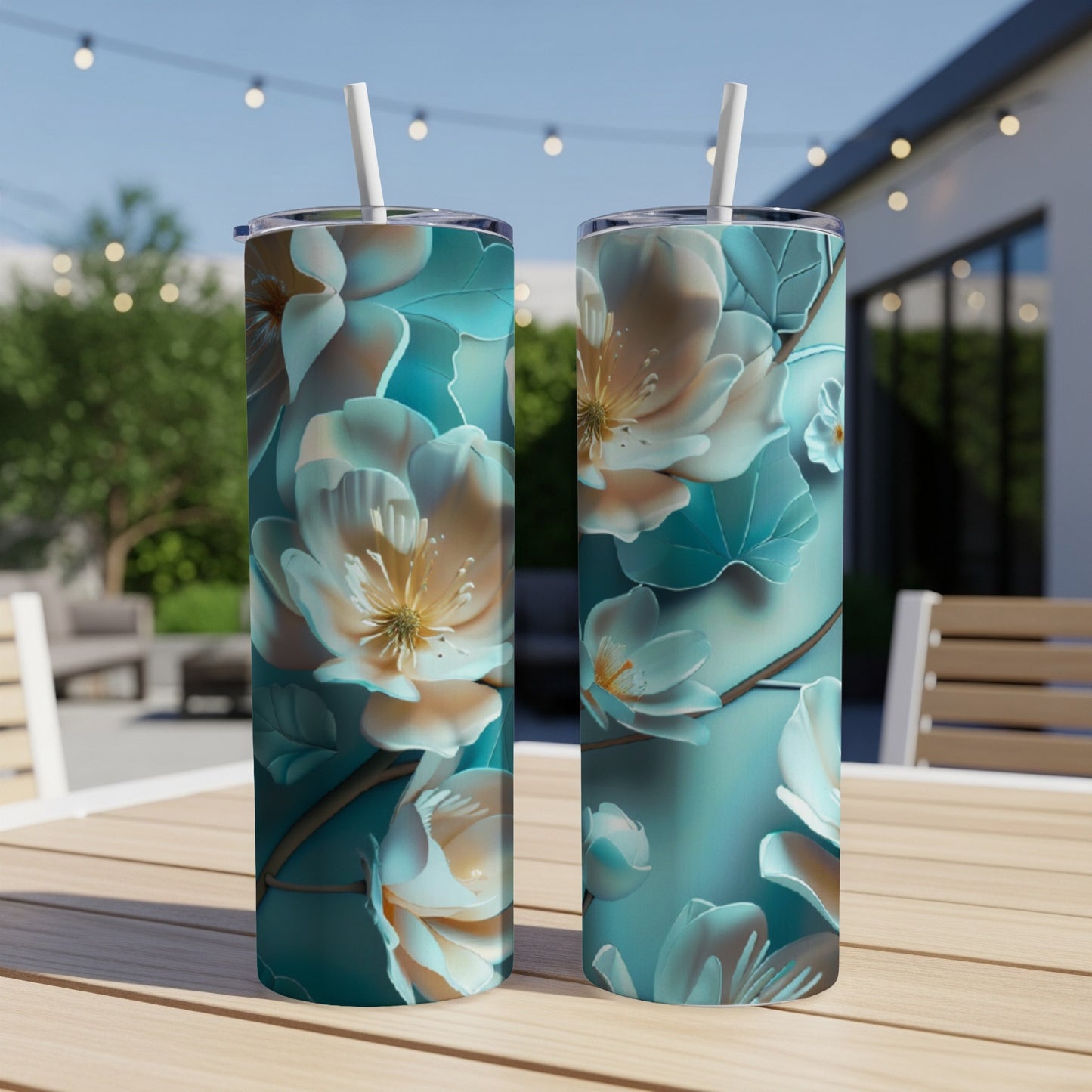 Two tall tumblers with a teal and cream floral design.