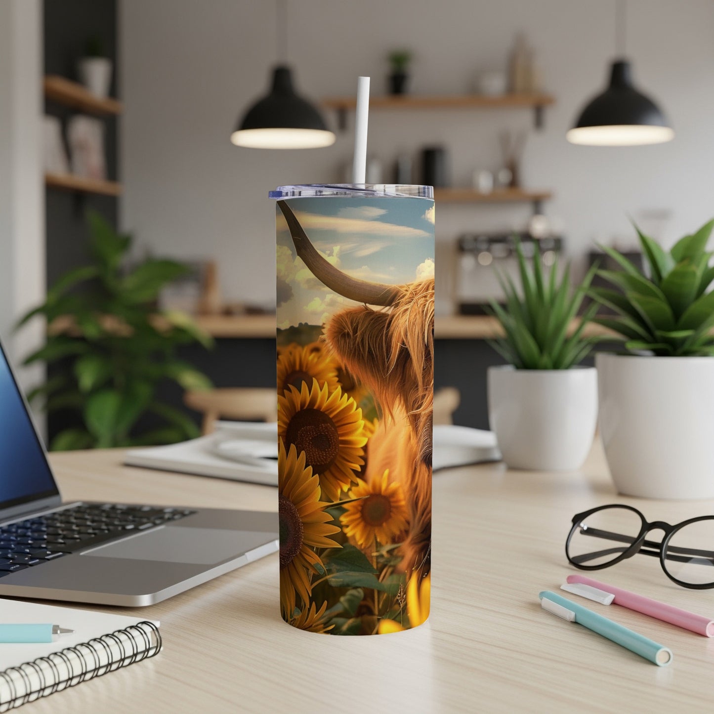Highland cow in a field of sunflowers on a white tumbler.