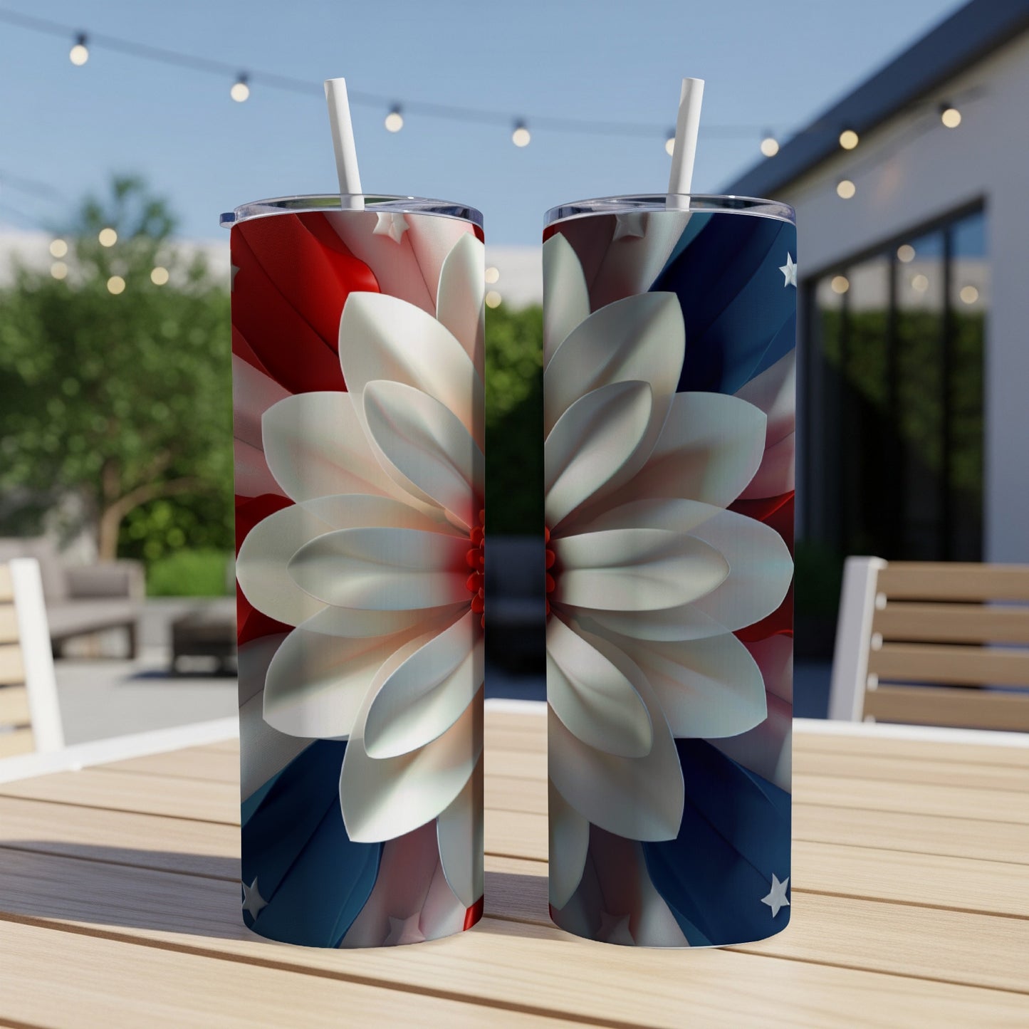 Two tumblers with floral patriotic design on an outdoor table.