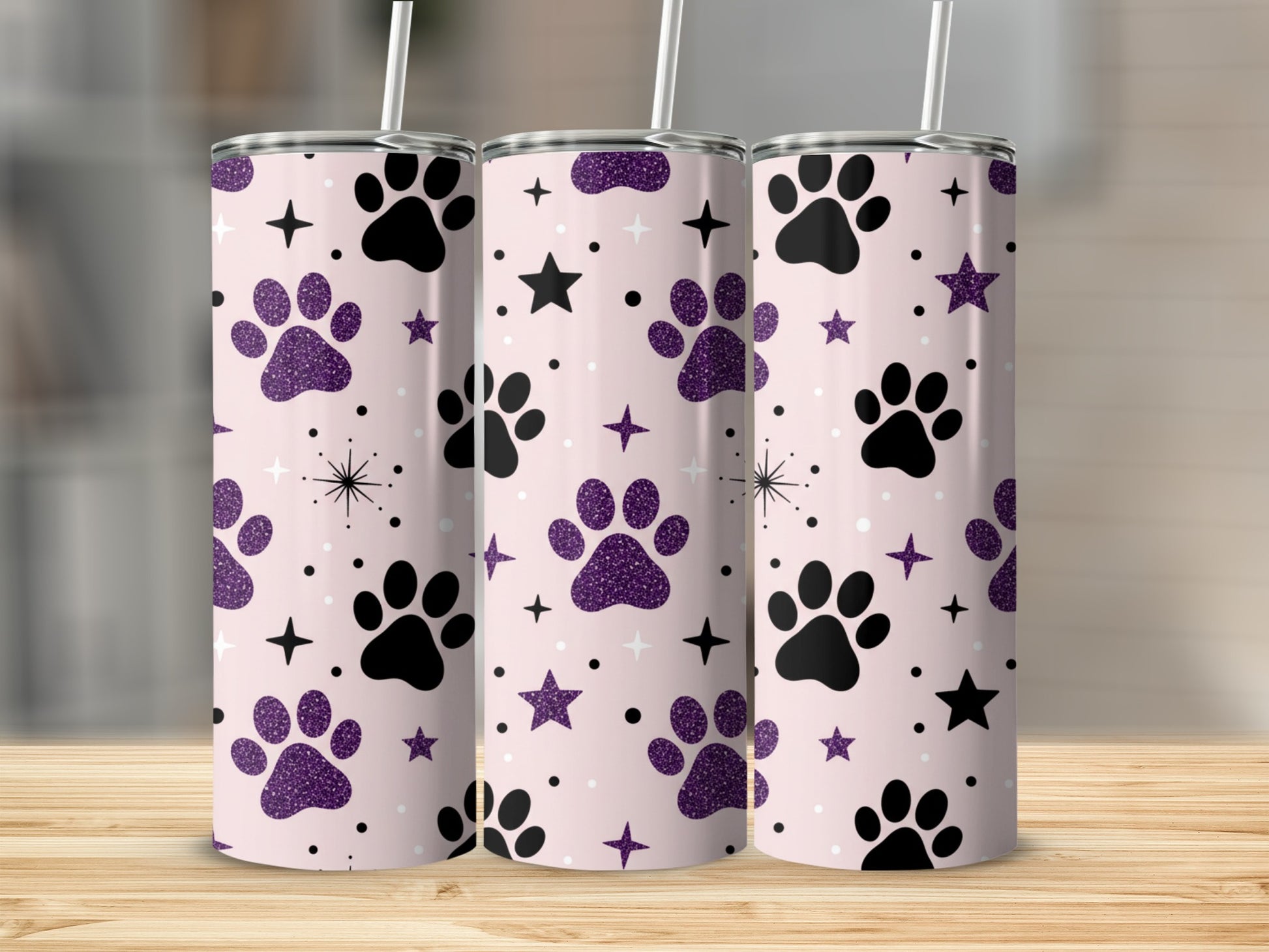 Pink tumbler with black paw prints and purple glitter stars.
