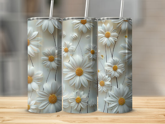 Three tall tumblers with white daisy floral patterns on a wooden surface.