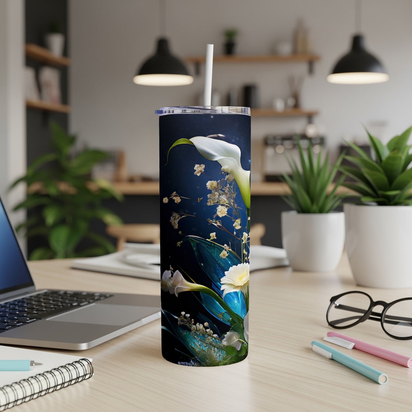 White calla lilies and yellow flowers on a dark background, on a tumbler.