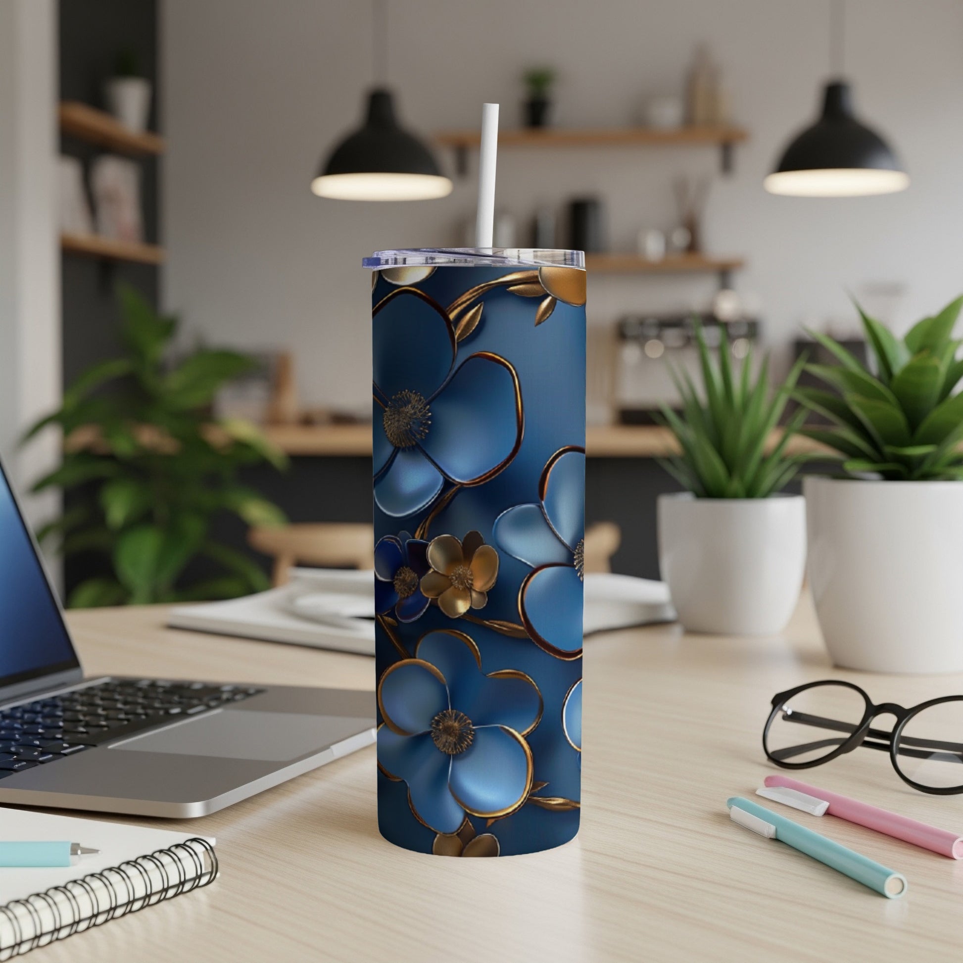 Blue tumbler with gold floral accents and a white straw.