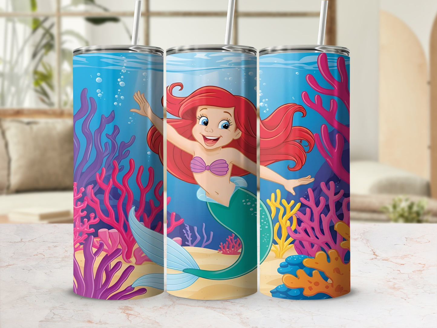 Ariel the mermaid swims in a colorful coral reef with bubbles.