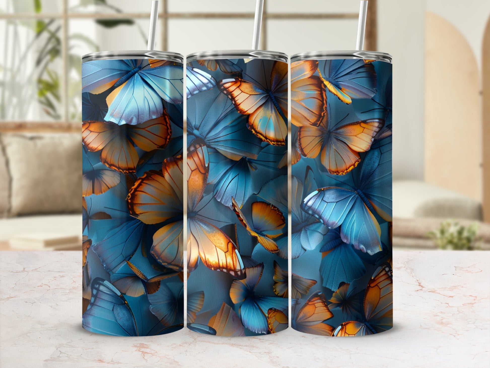 Triptych of tumblers with blue and orange butterfly patterns.