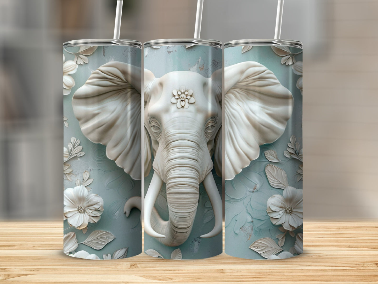 Three tall tumblers featuring a white embossed elephant head and floral pattern.