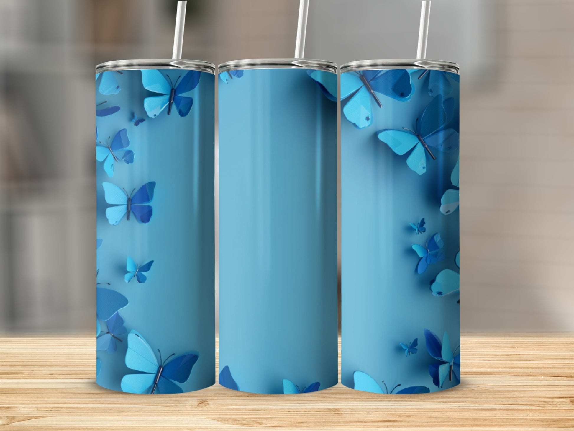 Blue tumbler with scattered blue butterflies and a straw.