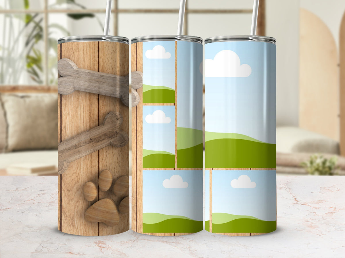 Three tumblers: one with wood grain, bone, and paw print; two with cloud and hill designs.