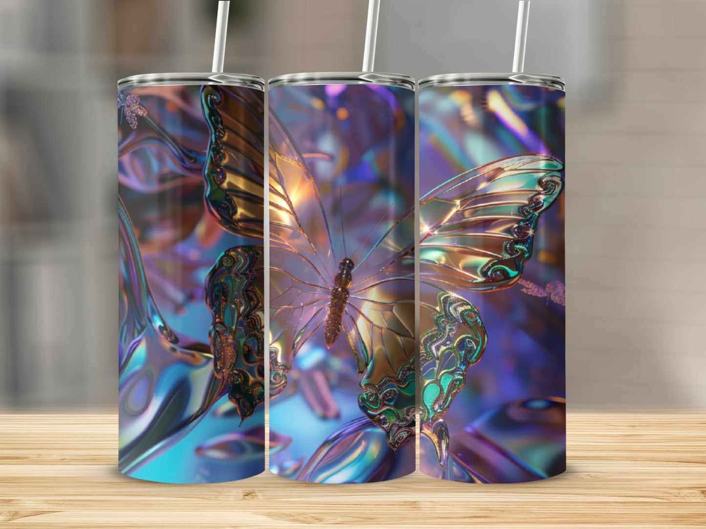 Three iridescent tumblers with a butterfly design, displayed on a wooden surface.