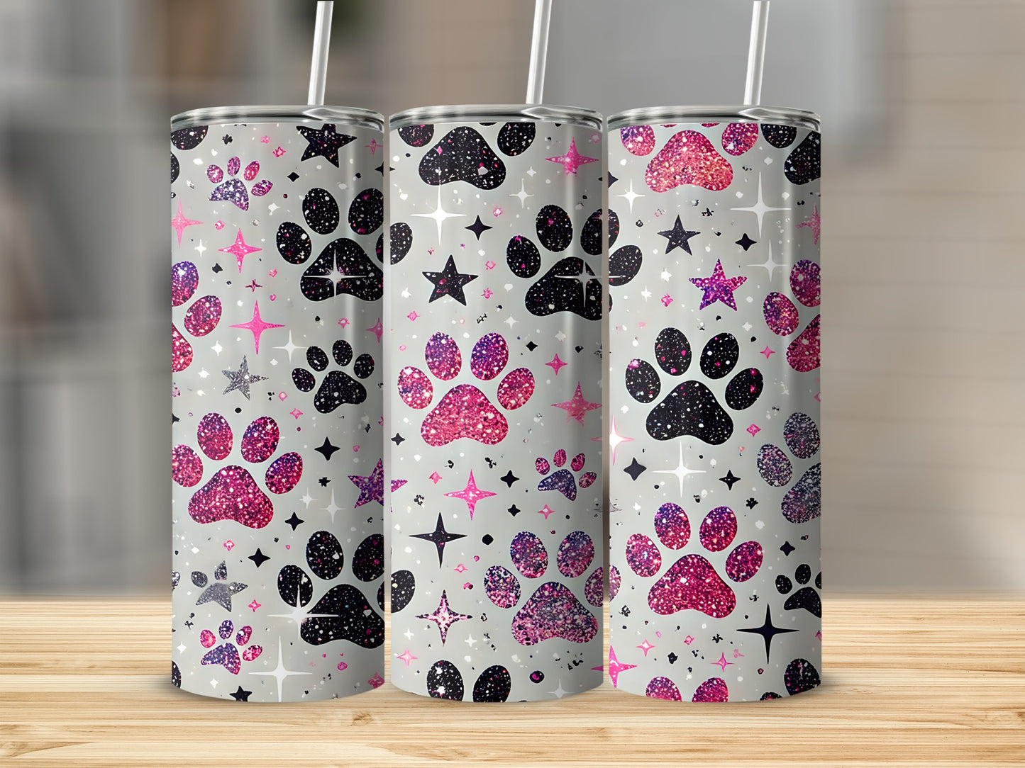 Three glittery paw print tumblers with stars on a light background.