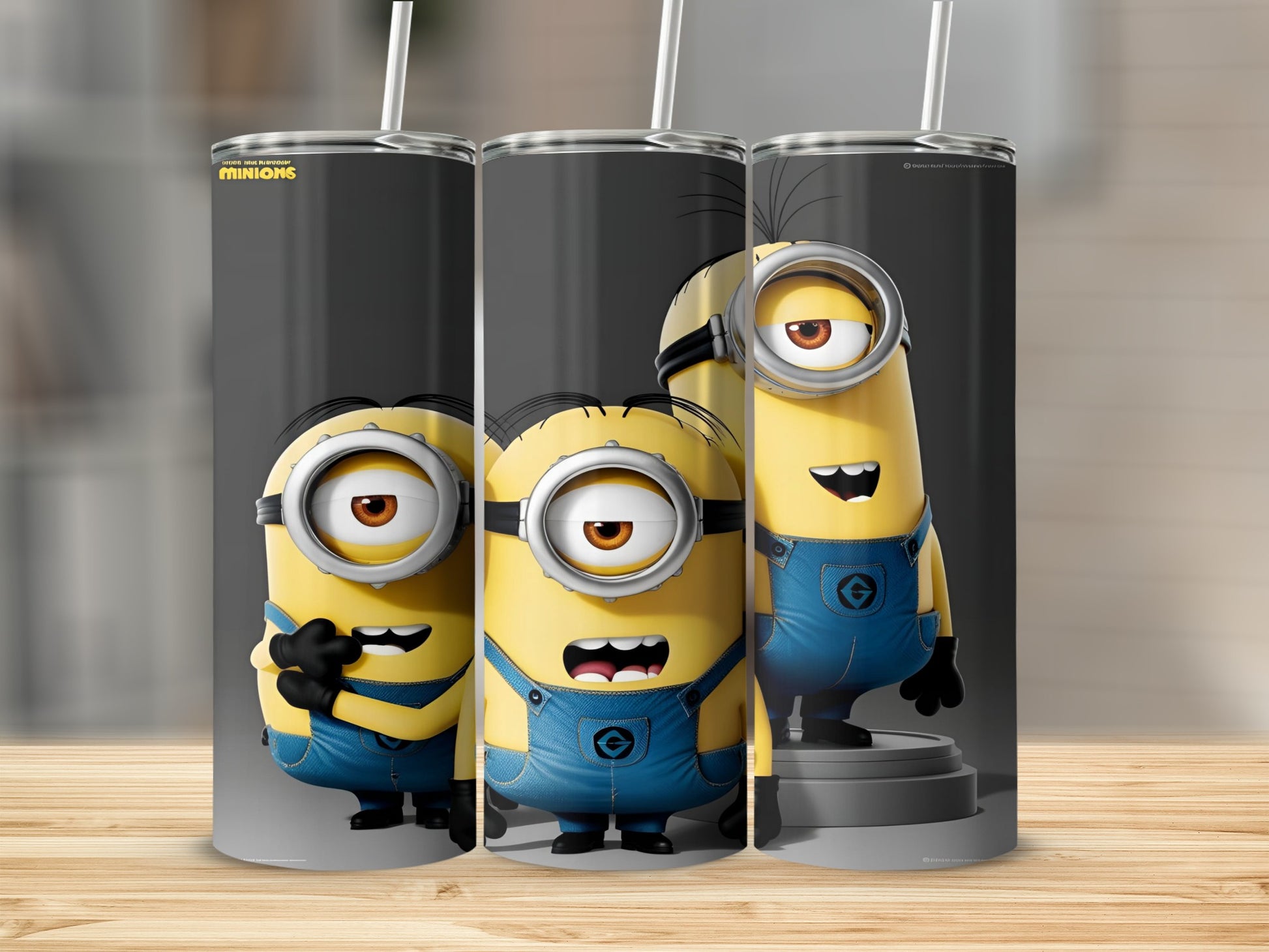 Three Minions from Despicable Me in blue overalls on a grey background.