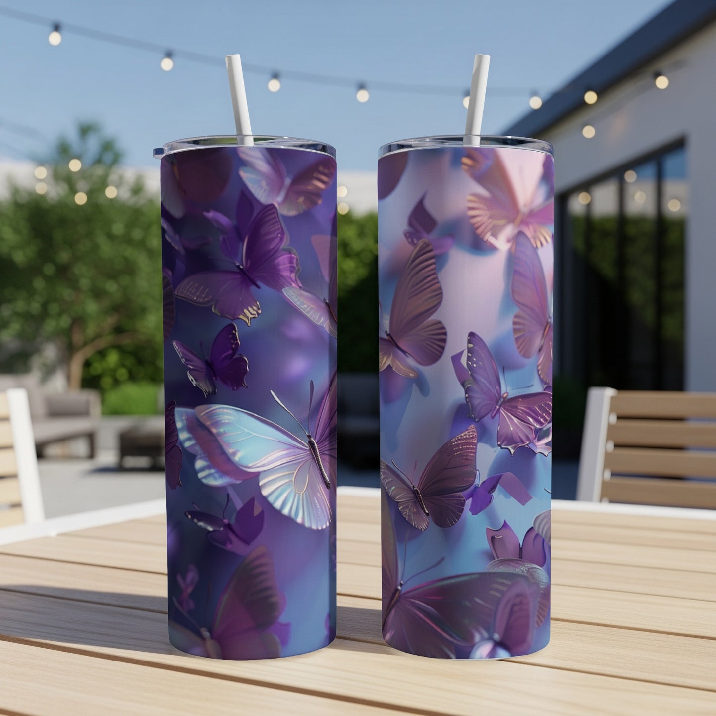 Two tall tumblers with purple and blue butterfly designs on a wooden table.