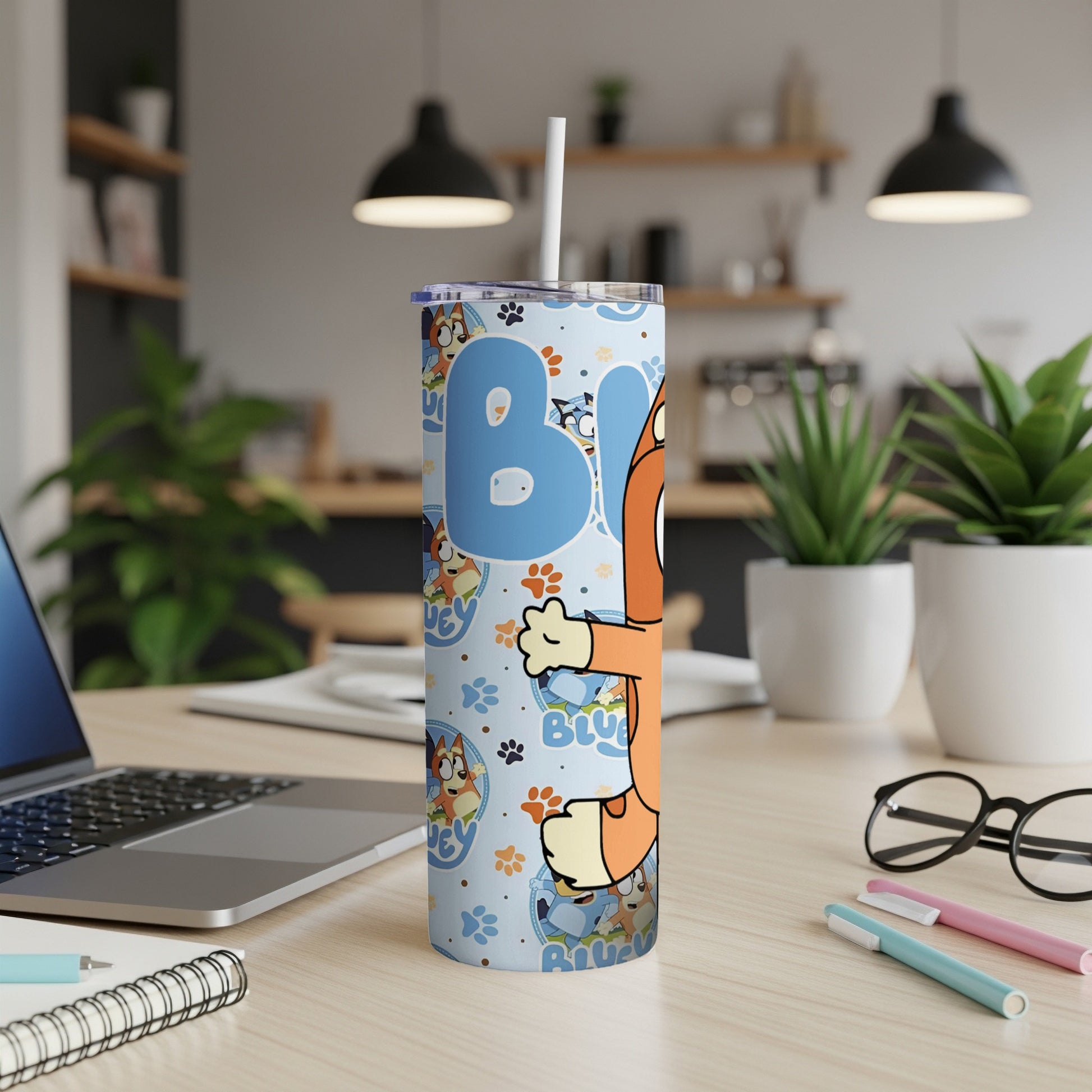 Bluey cartoon character on a blue patterned tumbler with a straw.