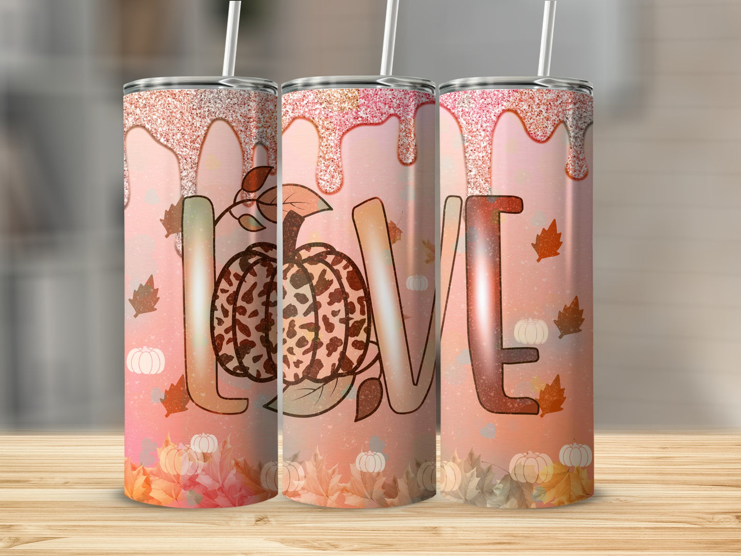 Three tumblers featuring a "LOVE" design with pumpkins and fall leaves.