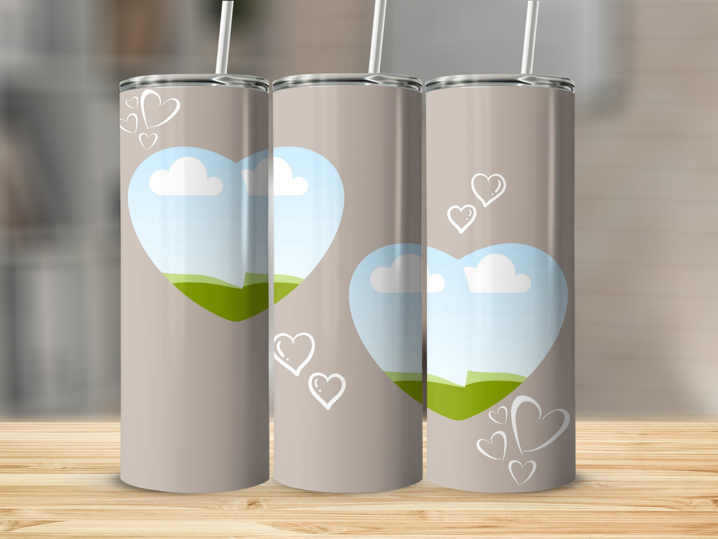 Three taupe tumblers with heart designs and sky landscape scenes.