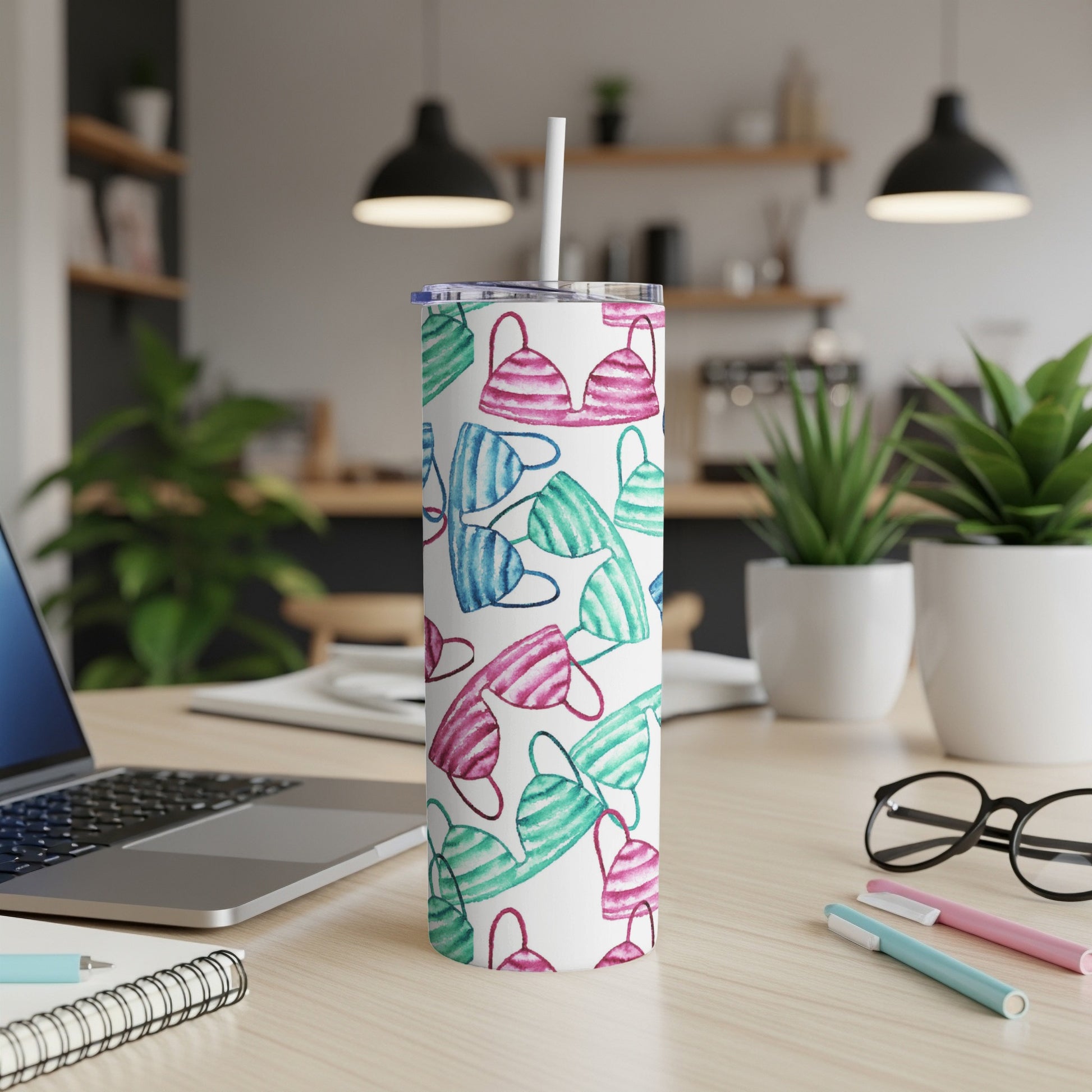 White tumbler with a pattern of colorful bikinis.