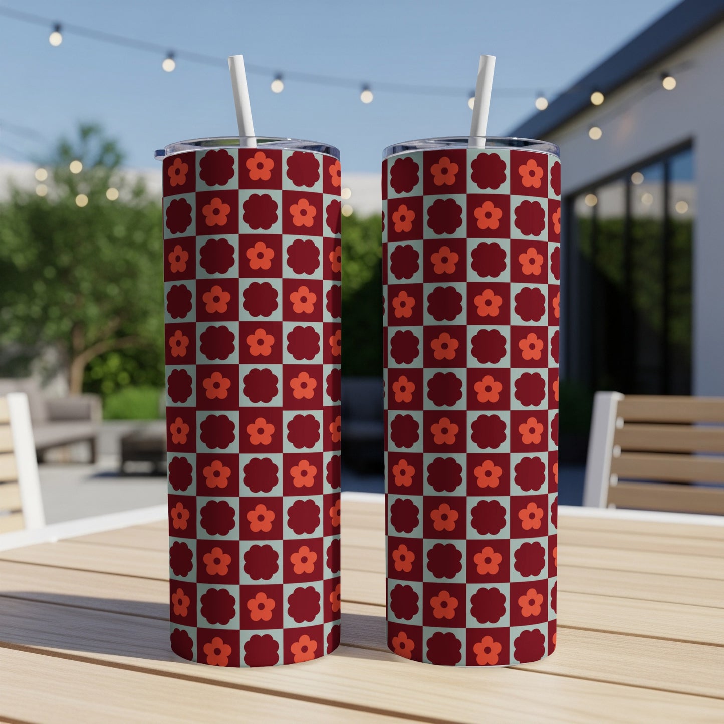 Two tall tumblers with a retro floral checkerboard pattern.