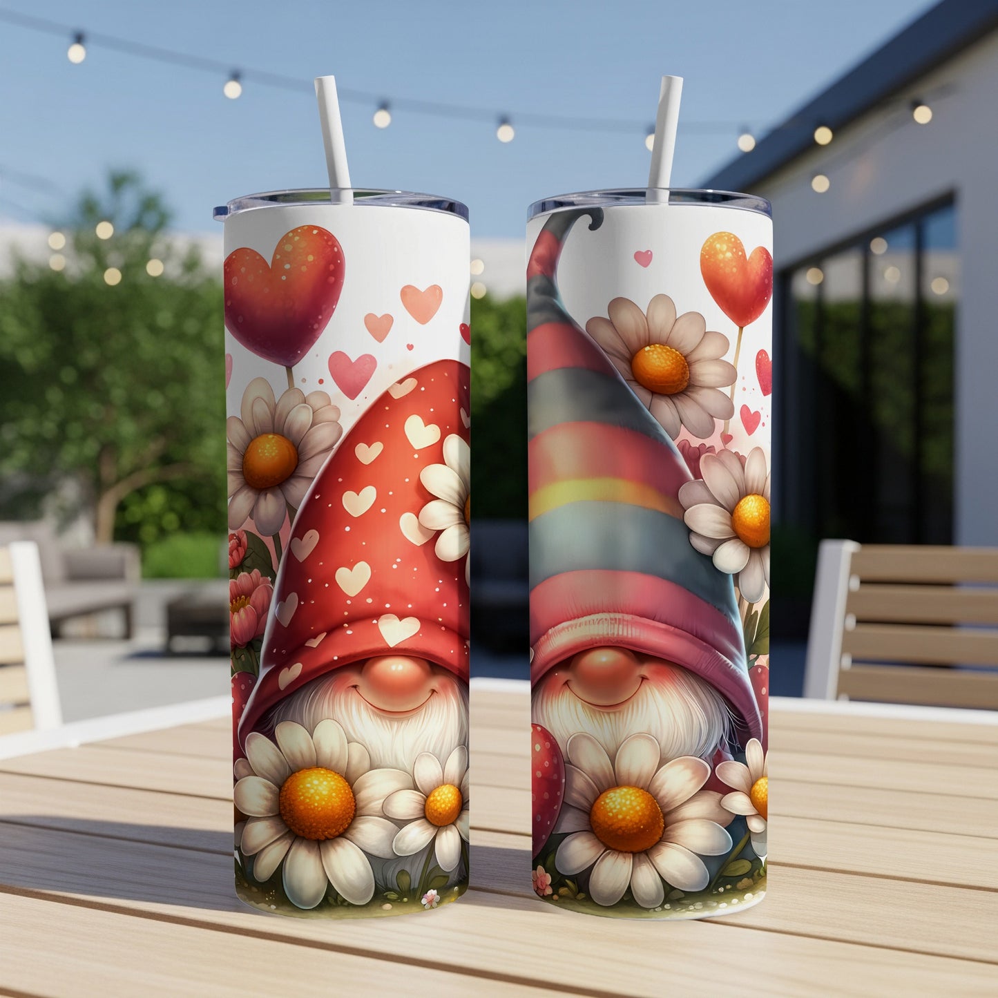 Two Valentine's Day gnomes with heart hats and floral designs on tumblers.