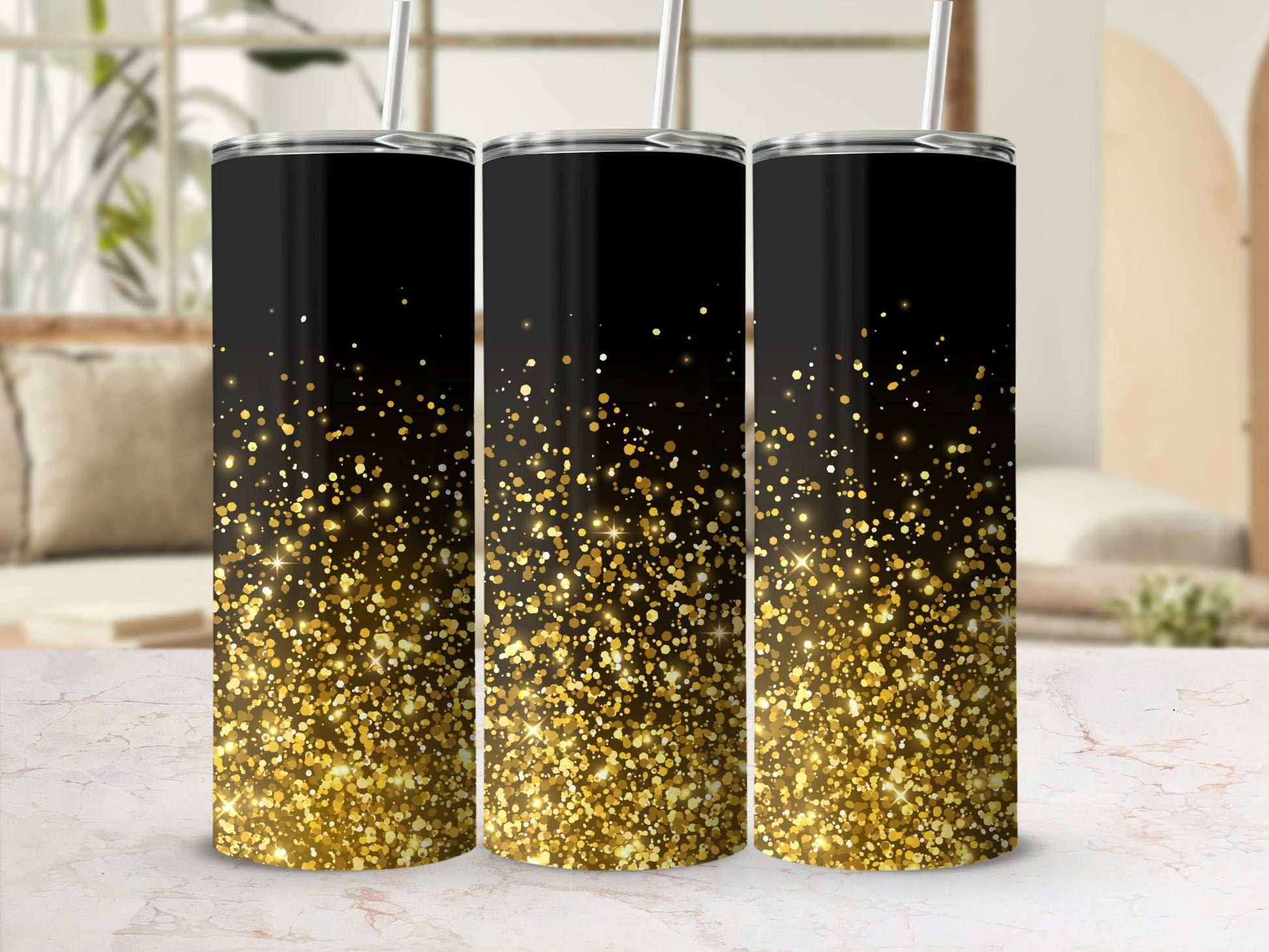 Three black tumblers with a gold glitter gradient, standing on a marble surface.