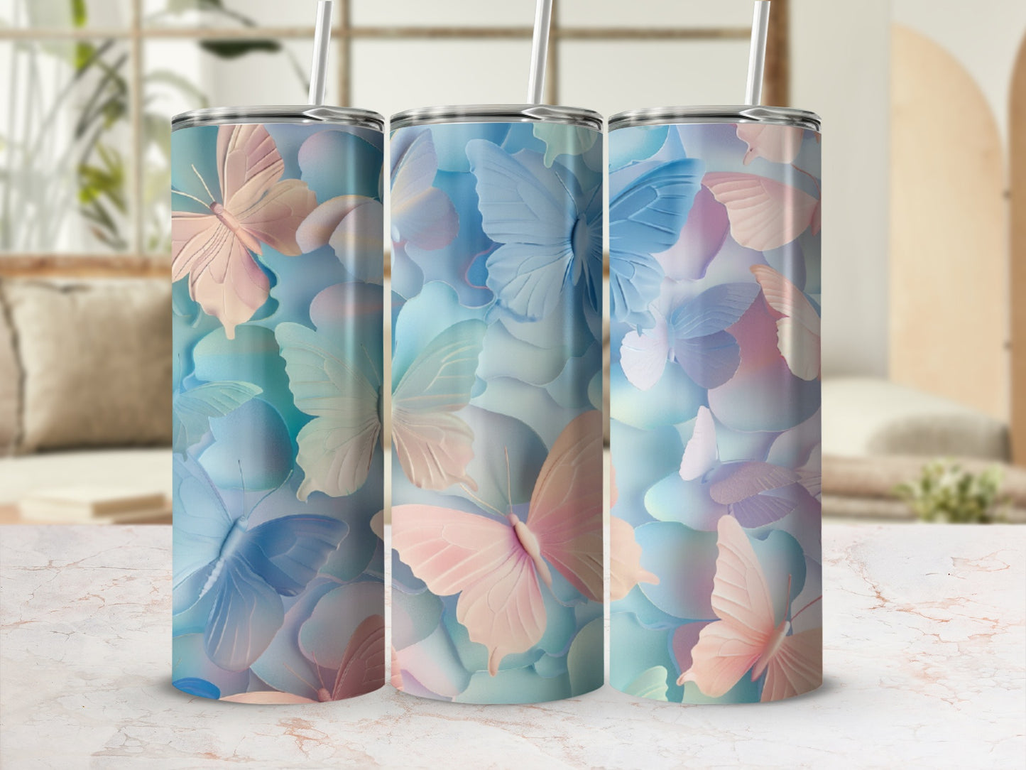 Three tall tumblers with pastel butterfly and petal designs.