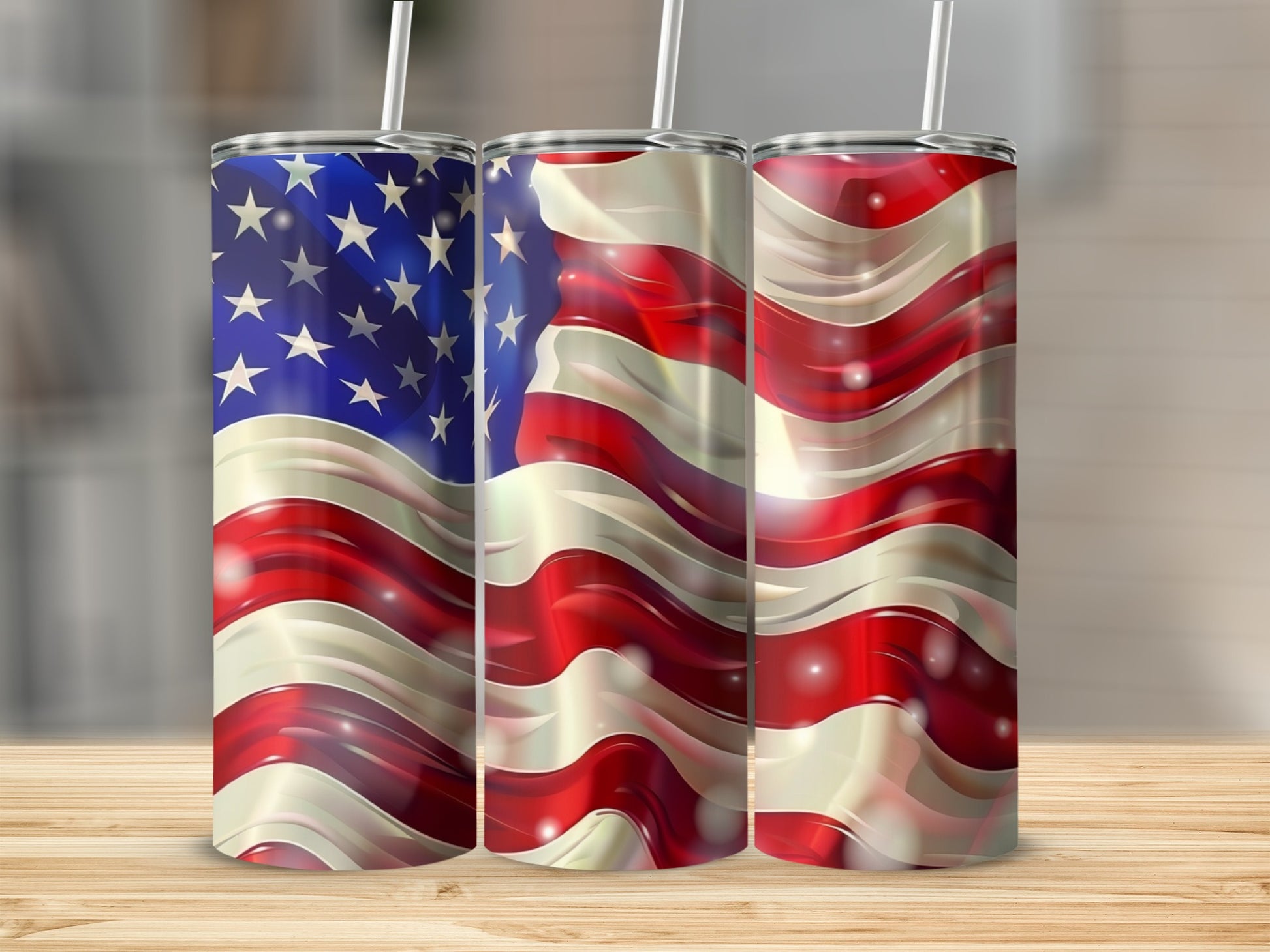 Three tumblers with wavy American flag design and white straws.