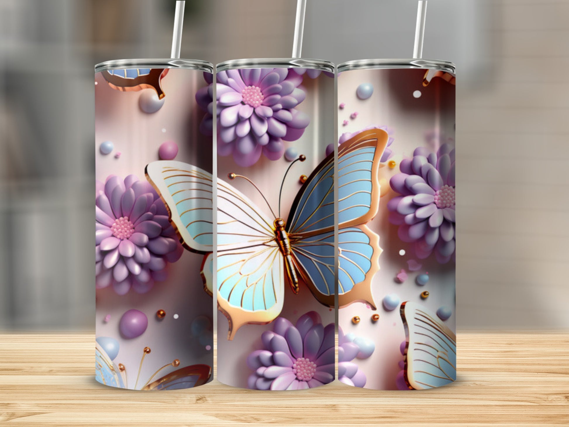 Three tumblers with butterflies and purple flowers on a wooden surface.