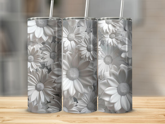 Three white floral tumblers with straws on a wooden surface.