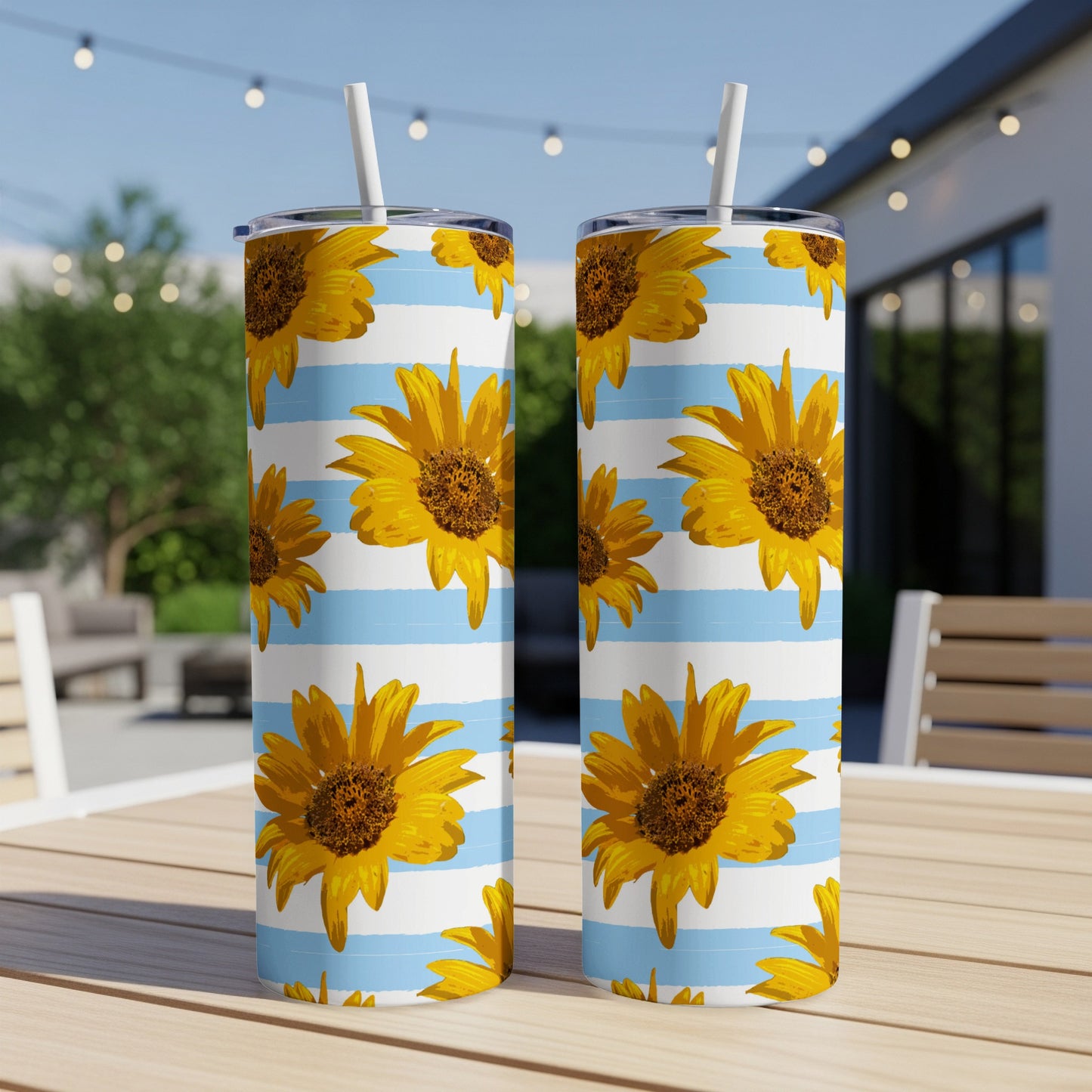 Two tumblers with sunflower and blue stripe pattern and white straws.