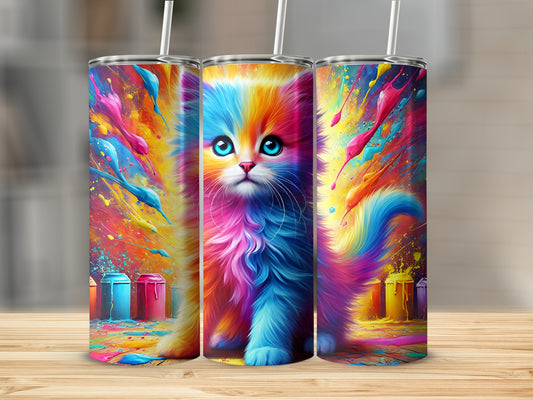 Fluffy kitten with rainbow fur sits against colorful paint splatters.