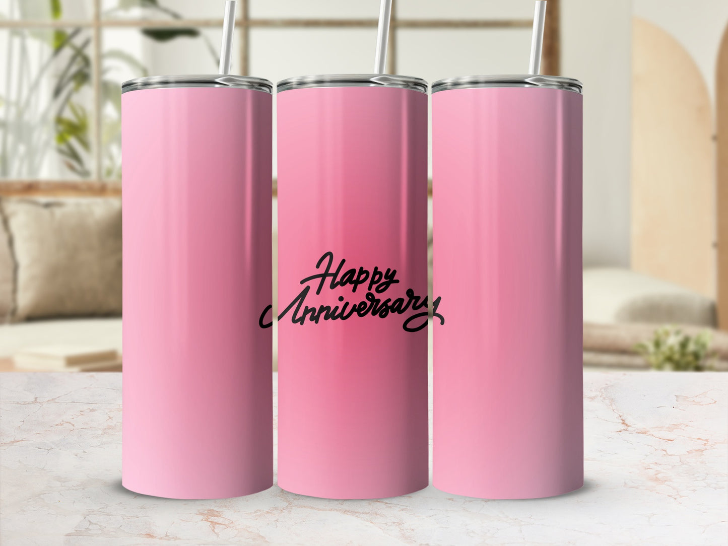 Pink tumbler with "Happy Anniversary" text and straw.